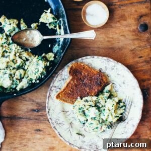 Fresh Start Chard Scramble 4 A small, artfully plated portion of Swiss Chard Scramble, showcasing the vibrant greens and fluffy eggs, garnished with fresh herbs, ideal for a wholesome breakfast.