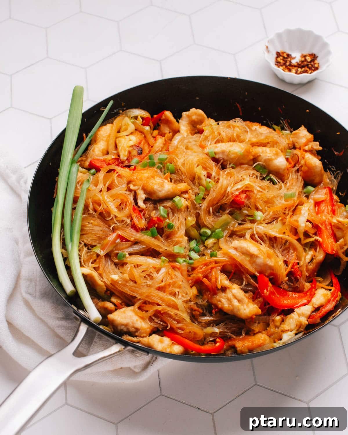 Pad Woon Sen Aromatic Glass Noodle Stir Fry 2 A beautifully plated Pad Woon Sen, Thai glass noodle stir fry, garnished with fresh green onions.