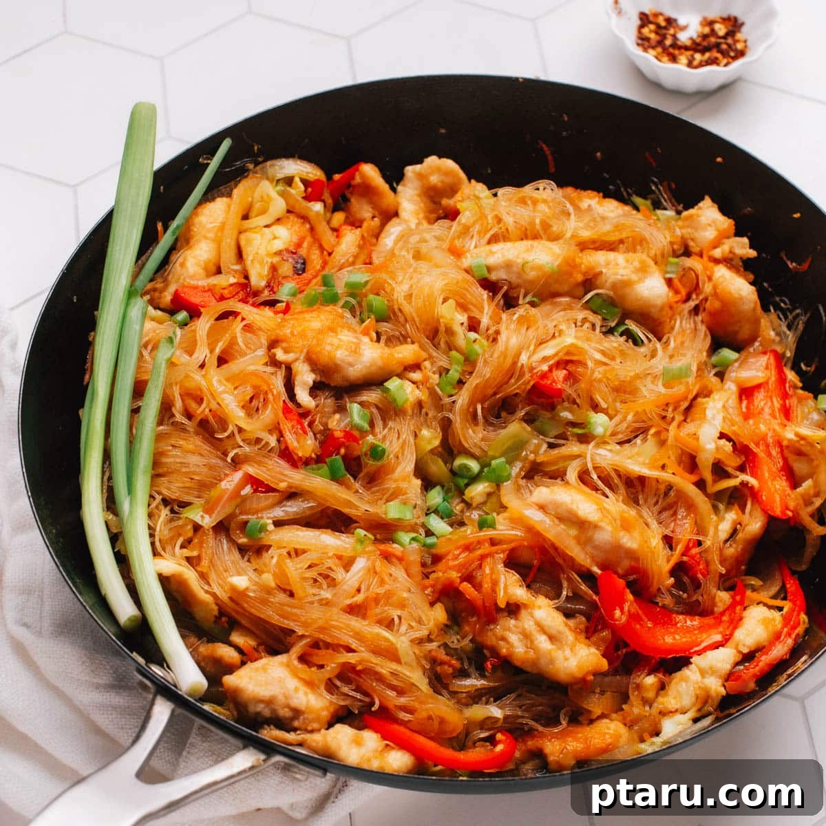 Pad Woon Sen Aromatic Glass Noodle Stir Fry 9 Pad Woon Sen (Thai Glass Noodle Stir Fry) is presented in a skillet, with a garnish of green onions on top.