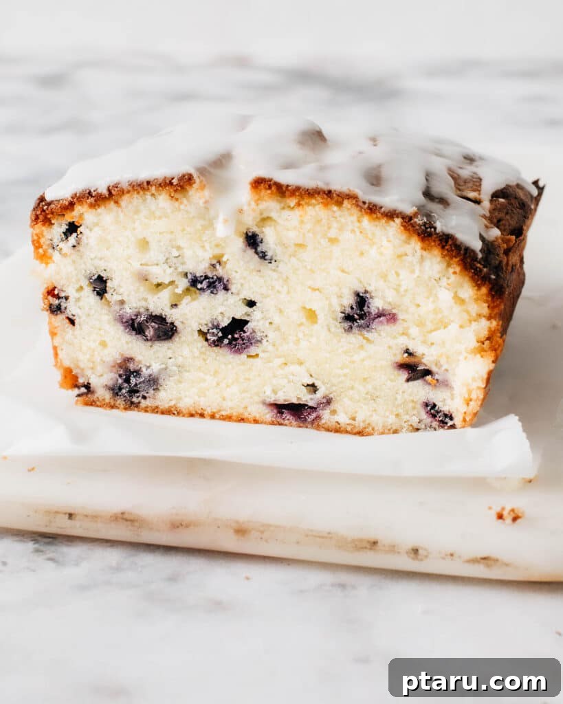 Buttery Blueberry Bliss Cake 2 A perfectly sliced blueberry pound cake showing its moist interior and evenly distributed blueberries.