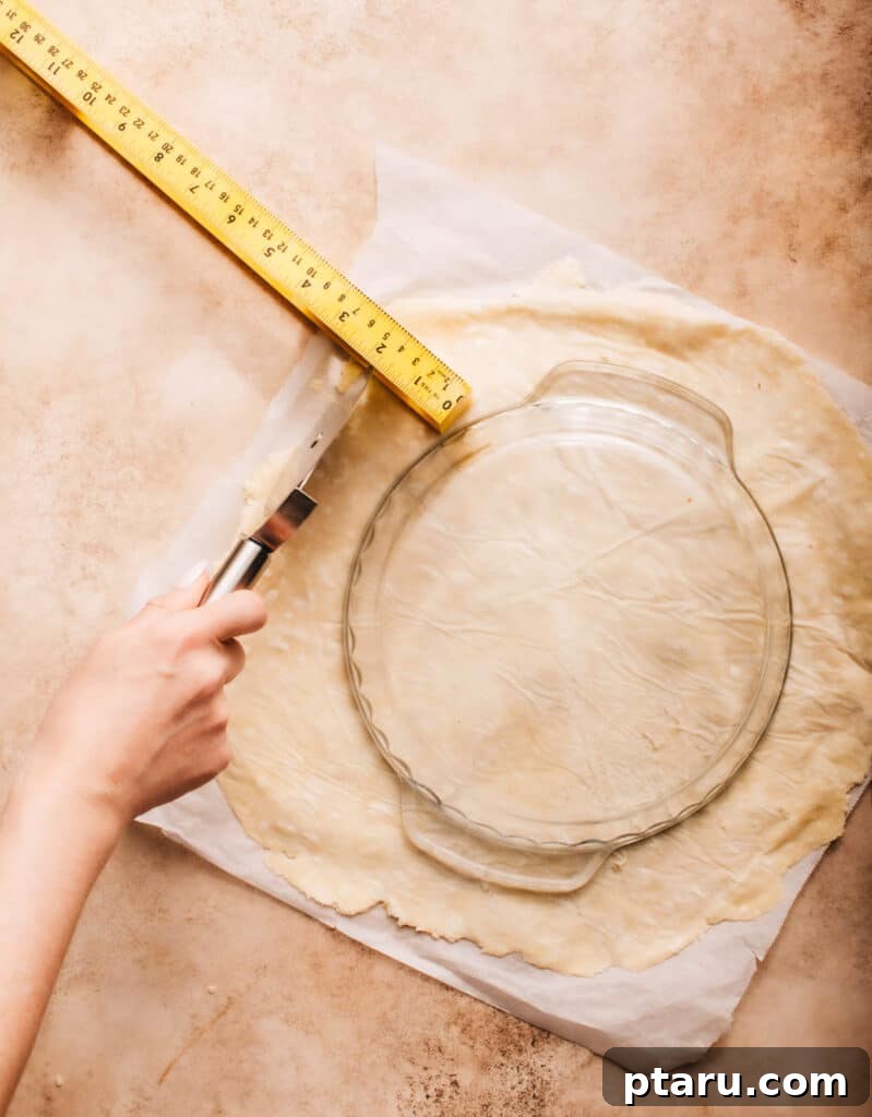Simple Hand-Mixed Pie Crust 17 Measuring a rolled-out pie crust to ensure it fits the pie pan.