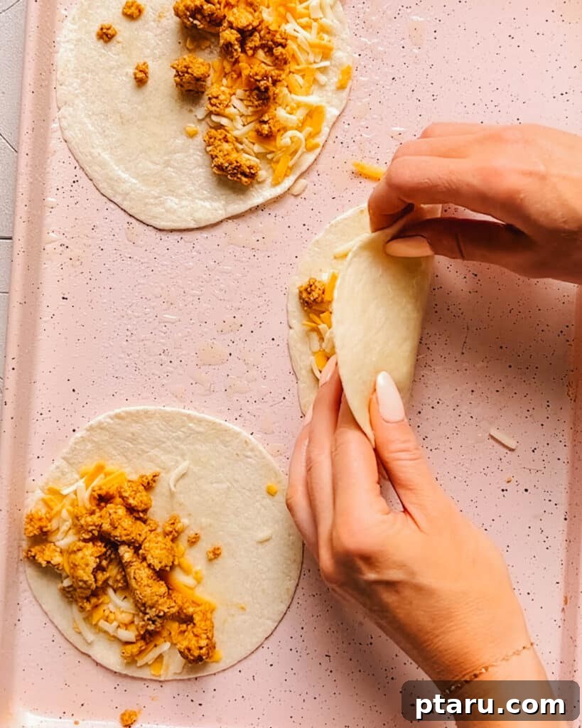 Fiesta Chicken Taco Blend 6 Assembling tacos with flavorful ground chicken using homemade chicken taco seasoning, topped with fresh ingredients.