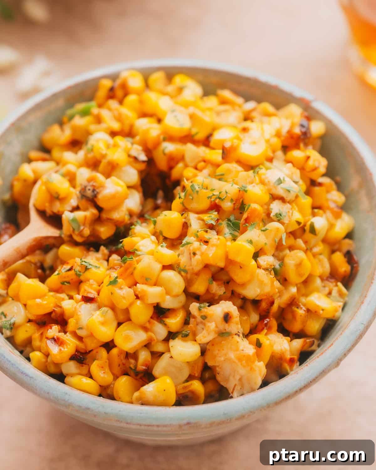 Zesty Mexican Elote Salad 2 A beautifully presented bowl of Mexican Street Corn Salad (Esquites) garnished generously with fresh cilantro and a sprinkle of chili powder, ready to be served as a vibrant side dish.