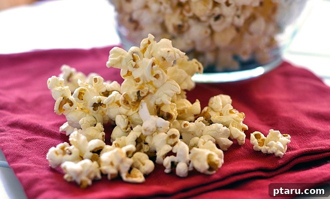 Sweet & Salty Pop Perfection 5 A large bowl of kettle corn ready to be served, with a hand reaching for a piece.