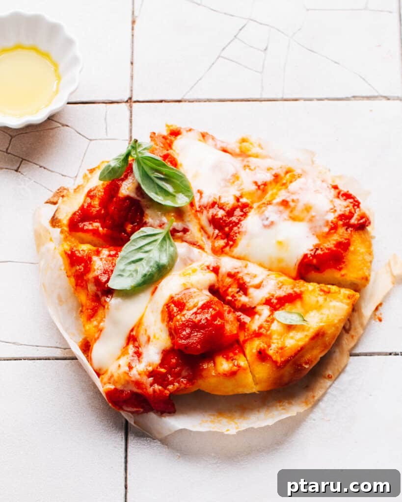 Effortless Air Fryer Pizza For Crispy Perfection 2 Air fryer pizza on a counter, freshly baked and ready to serve.