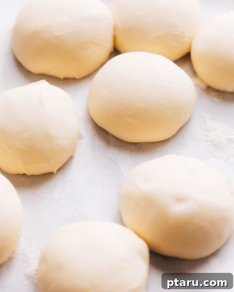 Effortless Air Fryer Pizza For Crispy Perfection 3 Balls of pizza dough, perfectly portioned and ready for rolling.