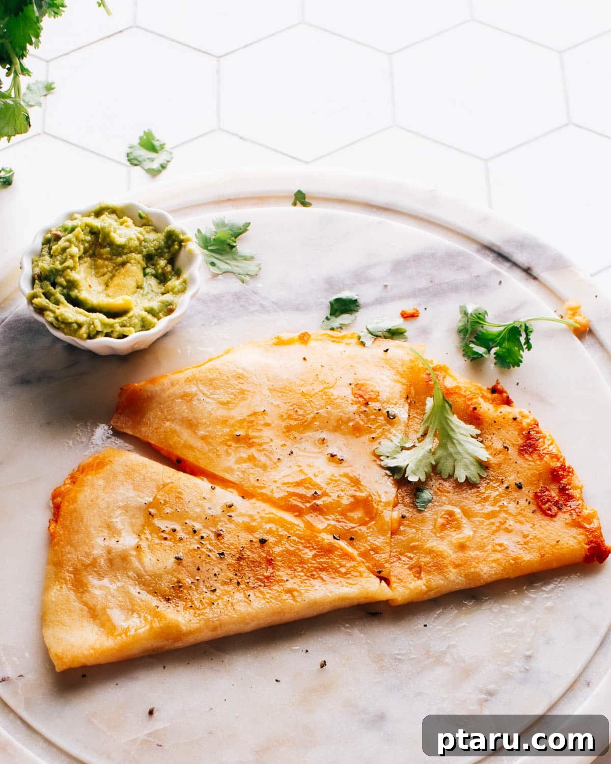Golden Cheesy Foldover 2 Wedges of golden cheese quesadillas, served alongside a small cup of luscious avocado crema.