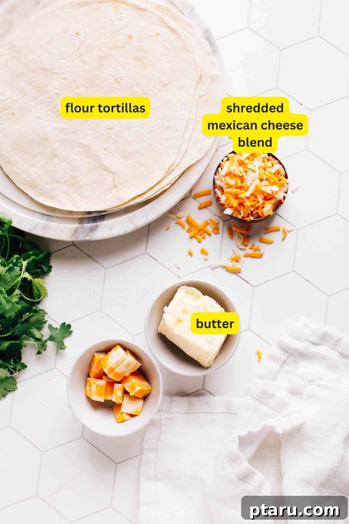 Golden Cheesy Foldover 4 A clean kitchen countertop displays the simple ingredients for a cheese quesadilla: fresh flour tortillas, a generous bowl of shredded Mexican cheese blend, and a stick of butter.