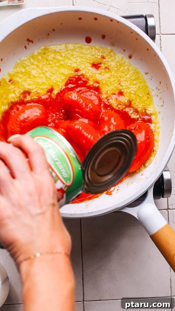 Homemade Pizza Sauce: The Only Recipe You'll Ever Need 6 Adding tomatoes to the pizza sauce.