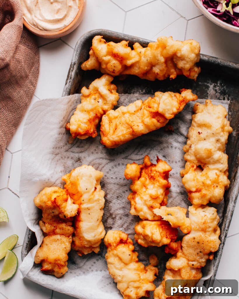 Authentic Baja Fish Tacos Recipe: Featuring Our Signature Sauce 6 Fried Baja fish for tacos on a paper towel-lined plate.