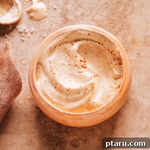 A high-angle shot of a bowl of homemade Baja sauce, its creamy texture and rich color signaling deliciousness, ready to be paired with various Mexican dishes or used as a dip.