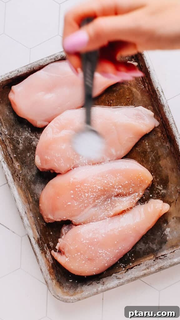 Easy 30 Minute Creamy Tuscan Chicken 4 Seasoning chicken breasts with salt and pepper for the Tuscan chicken recipe.