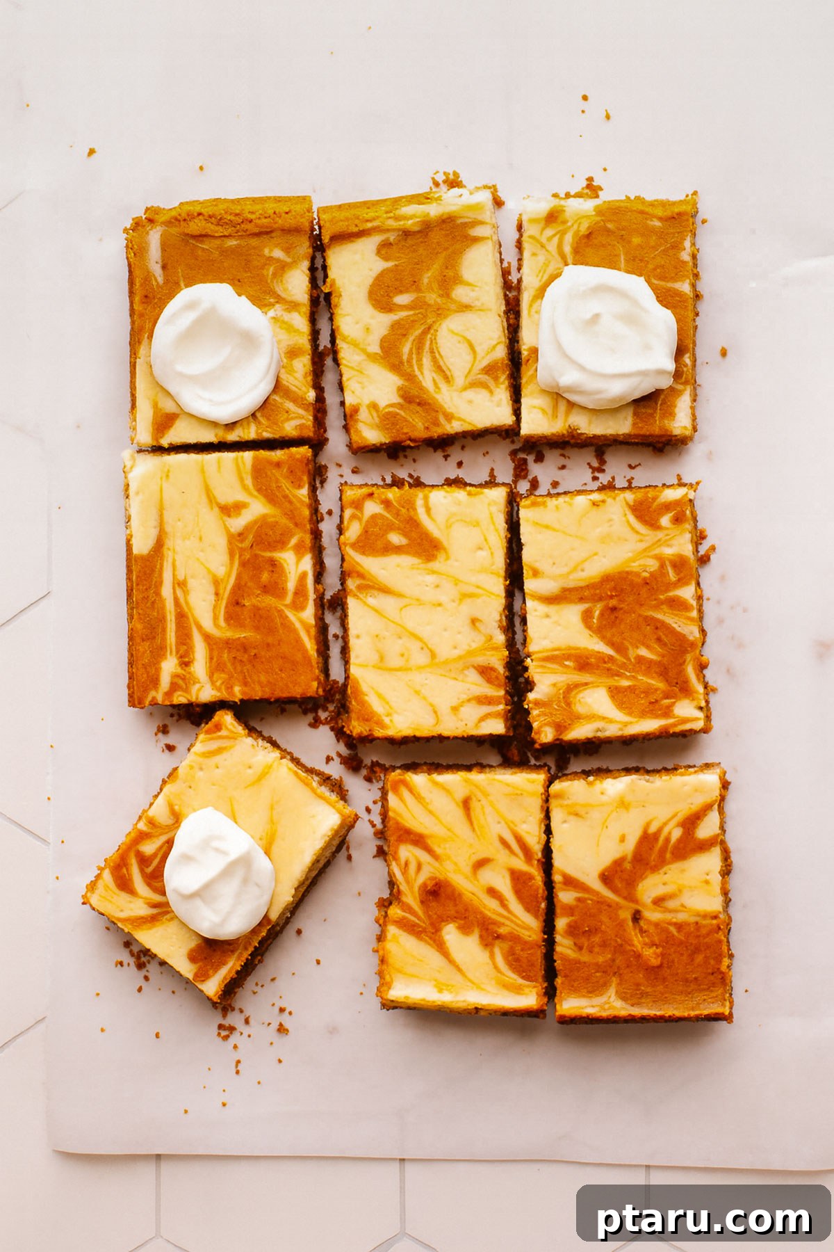Easy Pumpkin Cheesecake Bars 2 Beautifully garnished Pumpkin Cheesecake Bars with whipped cream.