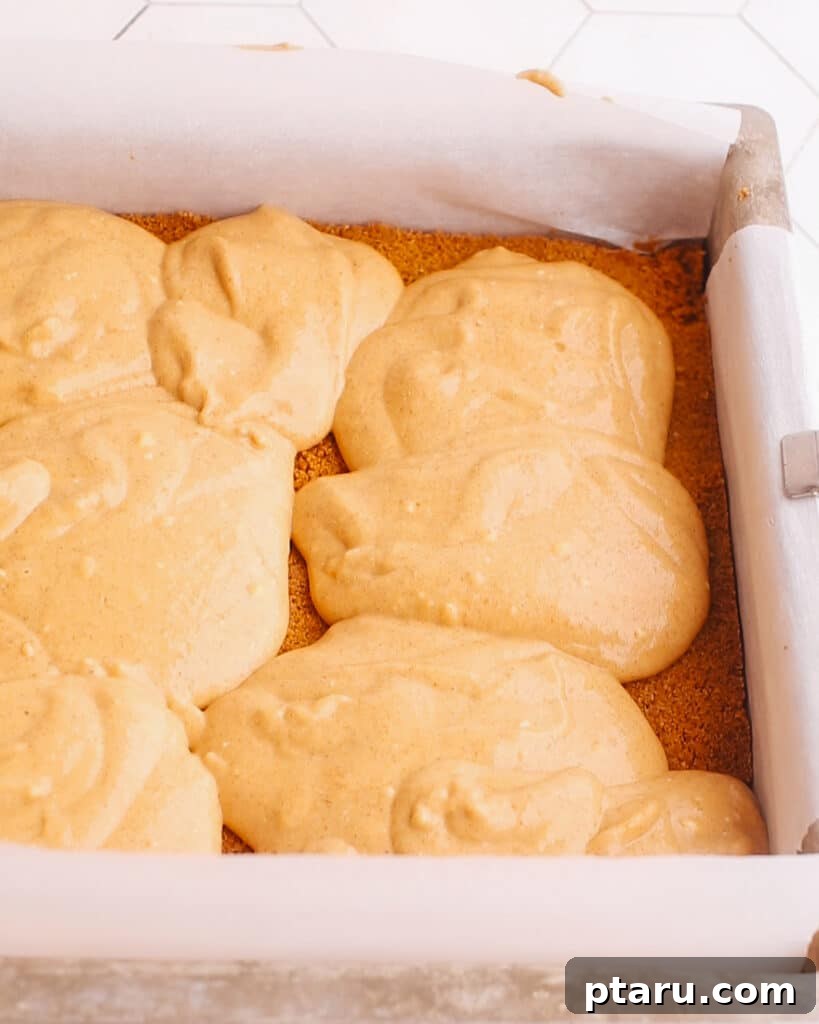 Easy Pumpkin Cheesecake Bars 5 Adding pumpkin cheesecake batter to the pan.