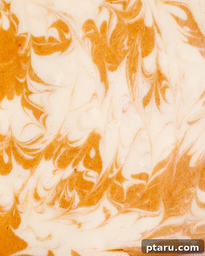 Easy Pumpkin Cheesecake Bars 9 Up-close shot of the pumpkin cheesecake swirled batter before baking.
