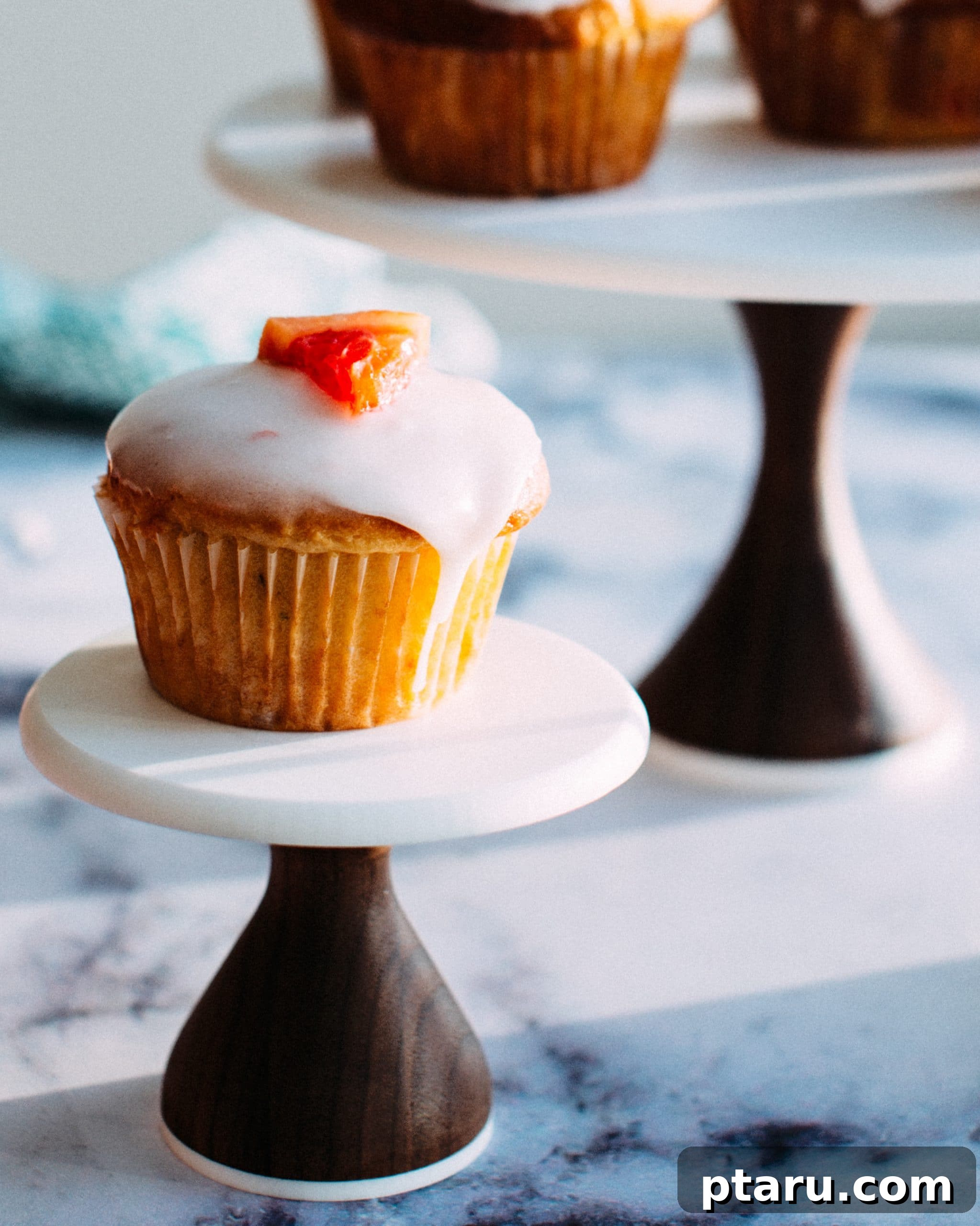 Tangy Grapefruit Yogurt Delights 2 Freshly baked grapefruit yogurt muffins with a delicate rosemary glaze, ready for breakfast