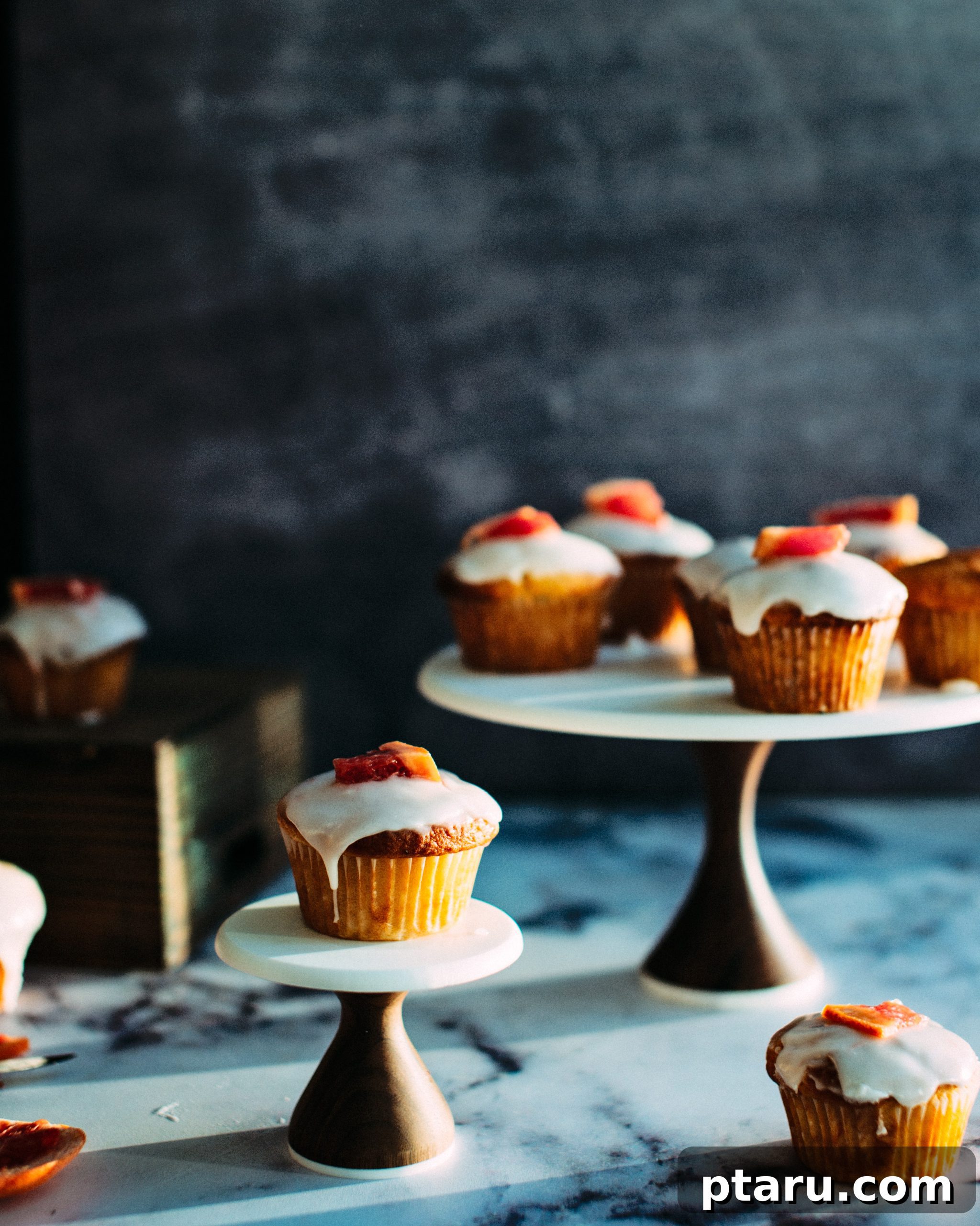 Tangy Grapefruit Yogurt Delights 4 A beautifully arranged serving of grapefruit yogurt muffins on a rustic wooden board, garnished with fresh rosemary sprigs and grapefruit slices