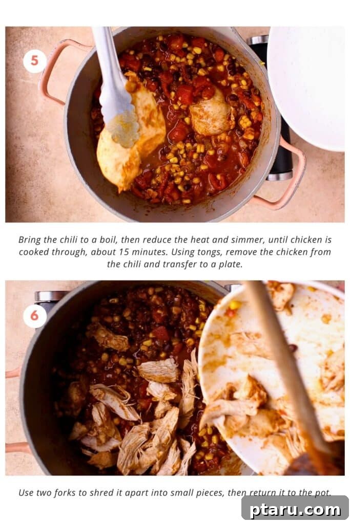 Velvety Cream Cheese Chicken Chili 6 Shredded cooked chicken being returned to the pot of simmering chili, creating a hearty and satisfying texture.