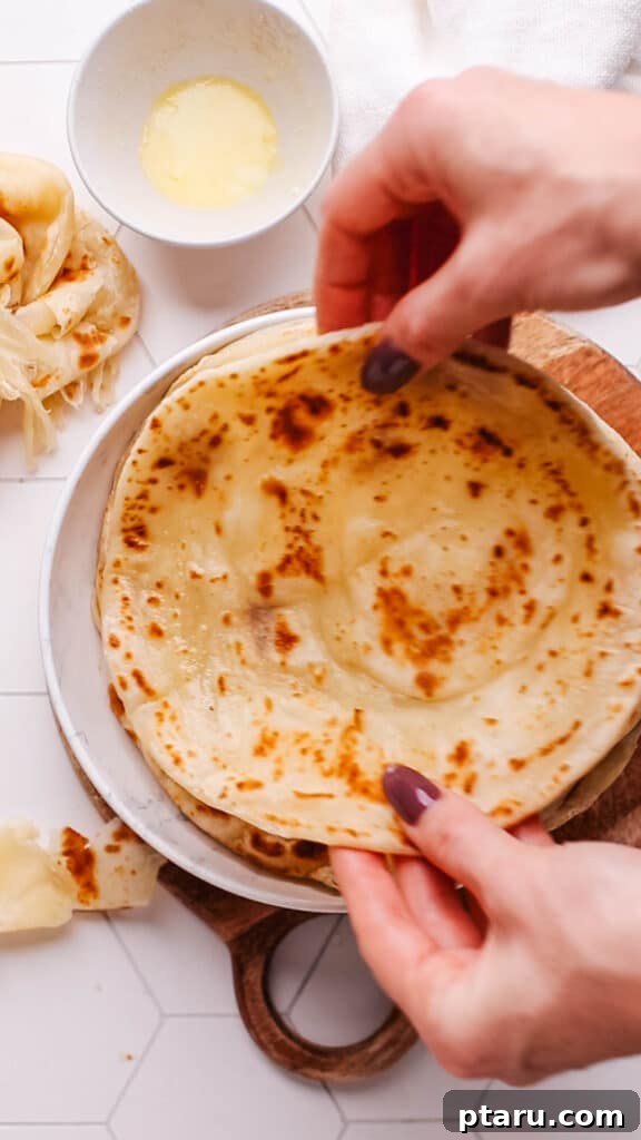 Paratha Golden Layered Indian Flatbread 20 Placing paratha on a plate.