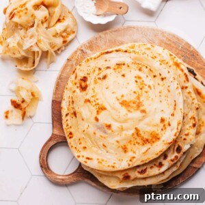 Paratha Golden Layered Indian Flatbread 22 Paratha on a board with some showing their flaky layers