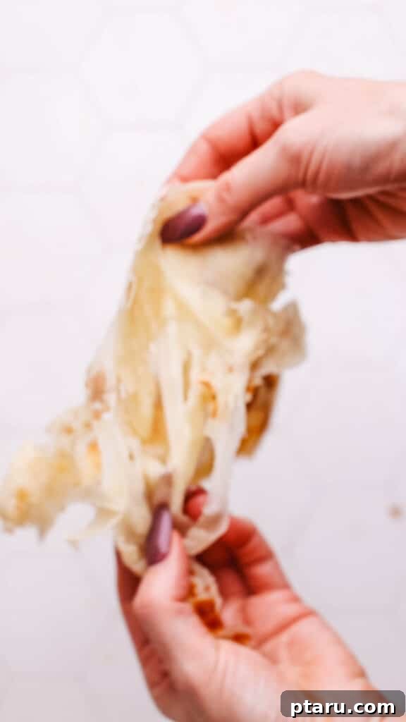 Paratha Golden Layered Indian Flatbread 4 Separating the flaky paratha layers.
