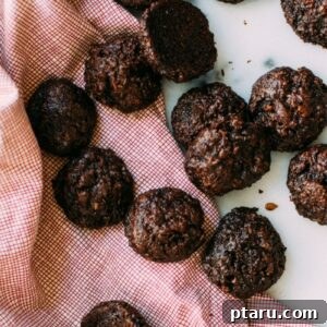 Close-up of chocolate coconut cookies on a decorative napkin, emphasizing their texture.
