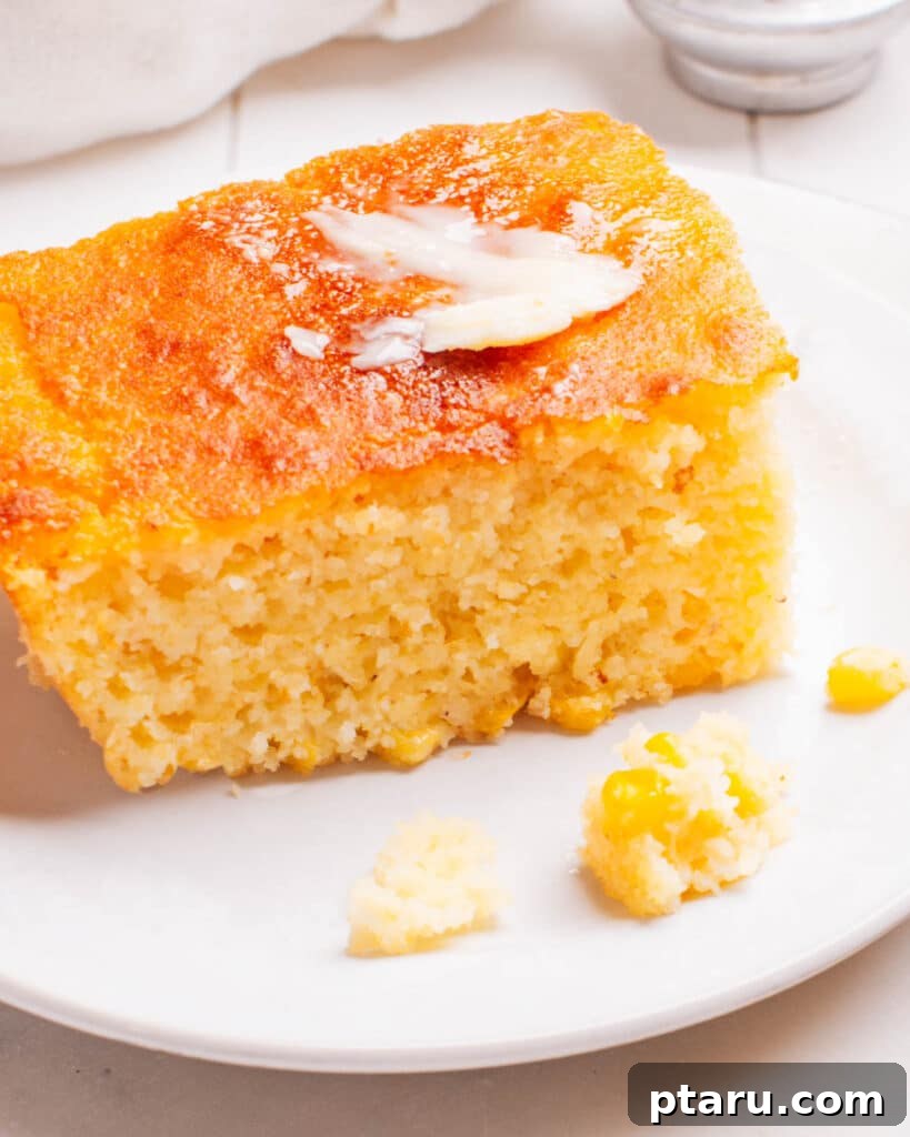 Golden Cornbread Bake 2 A piece of Cornbread Casserole on a plate with butter.
