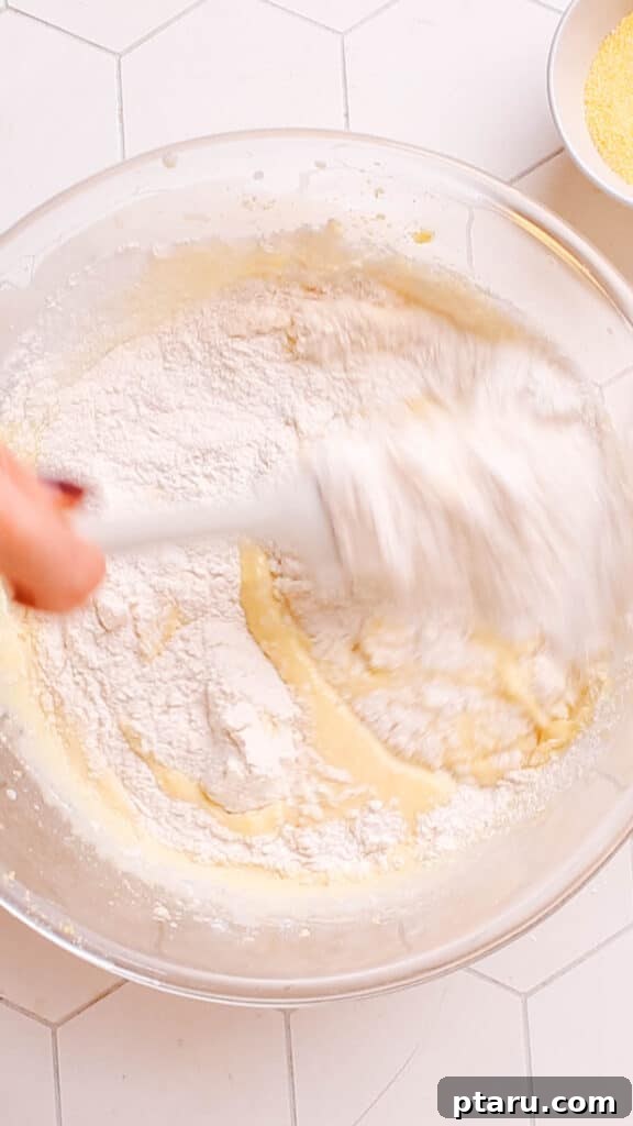 Golden Cornbread Bake 11 Combining wet and dry ingredients.