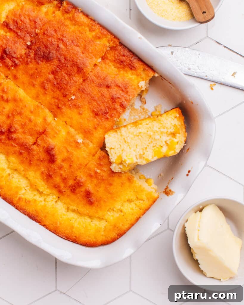 Golden Cornbread Bake 3 Cornbread casserole with a piece cut out.
