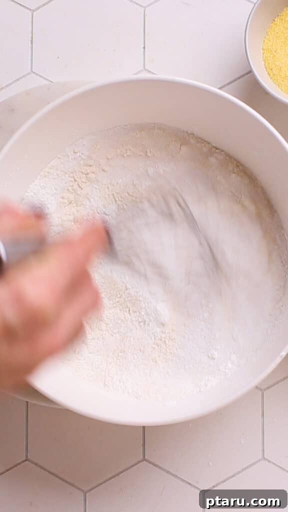 Golden Cornbread Bake 9 Mixing flour and dry ingredients for cornbread casserole.