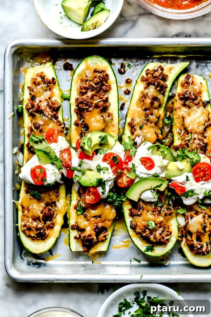 Over 35 Mouthwatering Leftover Taco Meat Recipes 14 Taco meat stuffed zucchini boats in a baking sheet