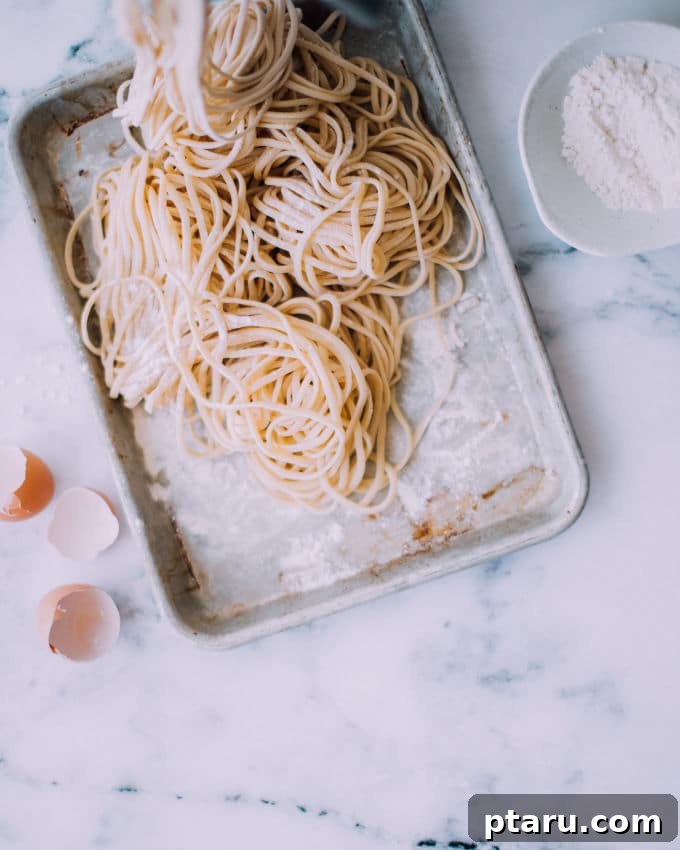 Crafting Perfect Homemade Pasta 5 Sheets of fresh pasta drying on a baking sheet, ready for cooking.