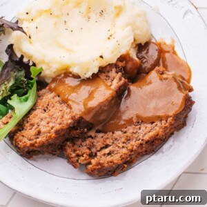 Lipton Onion Soup Meatloaf 10 Lipton Meatloaf Recipe and gravy on a plate with side dishes.