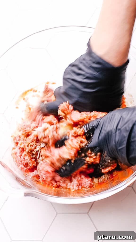 Lipton Onion Soup Meatloaf 5 Mixing Meatloaf Mixture in a bowl by hand.