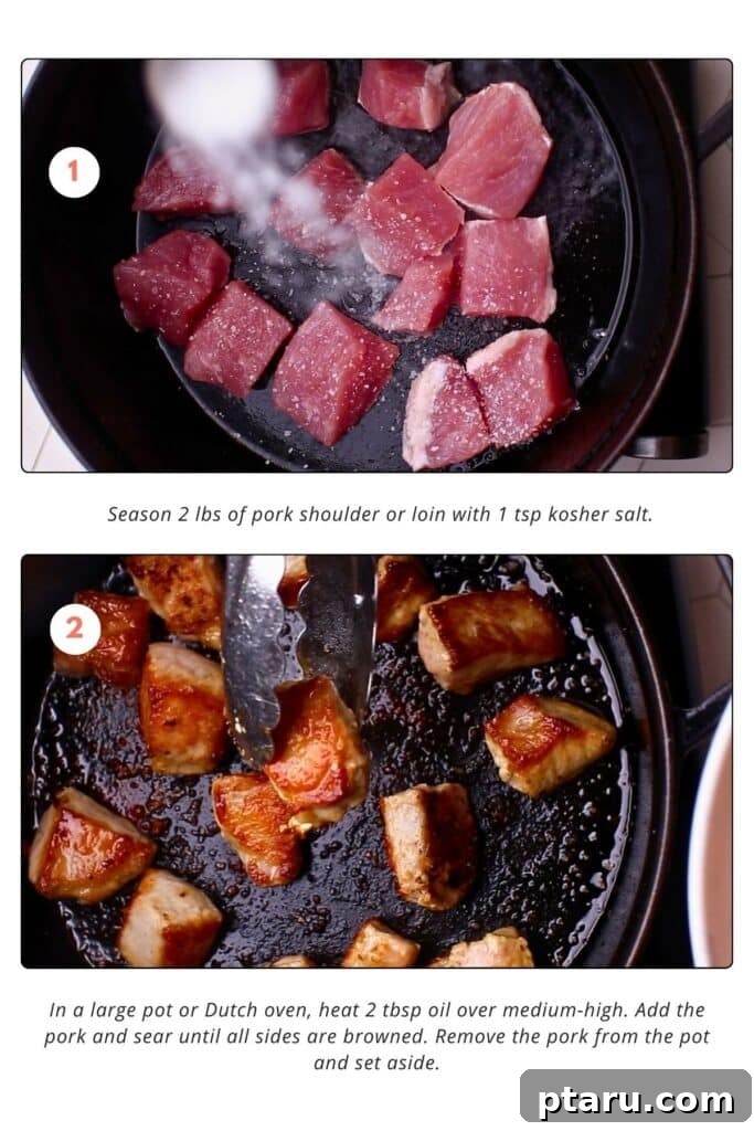 Award-Winning Pork Green Chili Recipe 5 Seasoned pork shoulder pieces are being sprinkled with kosher salt on a black skillet. The pork shoulder pieces are seared in oil in the skillet, turned to brown on all sides.