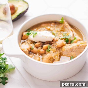 Effortless One-Pot Green Chicken Chili 9 A vibrant bowl of Green Chicken Chili, garnished with fresh toppings, ready to be enjoyed.