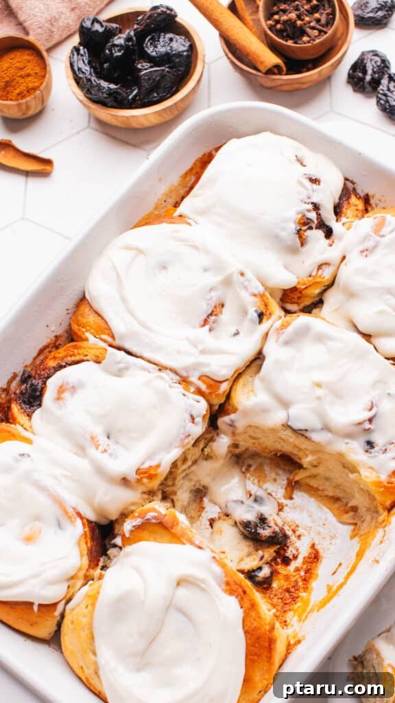 Sweet Cinnamon Raisin Swirls 2 Cinnamon buns with orange zest and dried fruit, ready to be served.