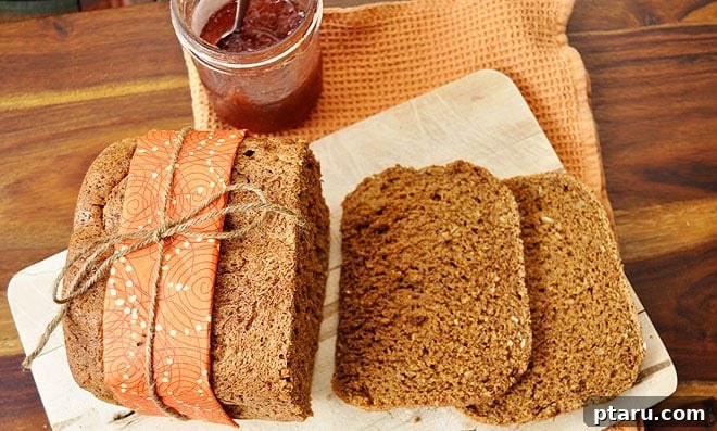 Artisan Multigrain Bread 2 A freshly baked loaf of golden-brown mixed grain bread, cooling on a wire rack.