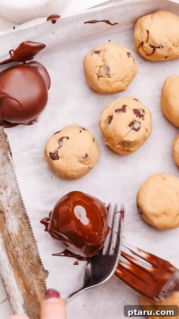 Effortless Cookie Dough Bliss 14 A baking sheet laden with freshly chocolate-dipped edible cookie dough bites, perfectly set and ready for storage or immediate indulgence.