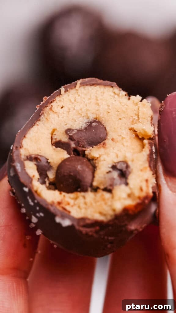 Effortless Cookie Dough Bliss 3 A close-up shot revealing the soft, gooey, chocolate-studded interior of a perfectly made edible cookie dough bite.