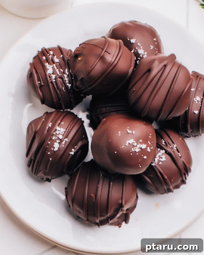 Effortless Cookie Dough Bliss 7 A beautifully presented plate of chocolate-coated edible cookie dough bites, ready to be enjoyed as a safe, no-bake dessert.
