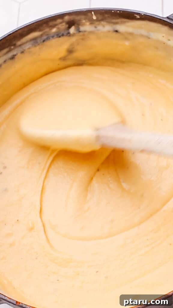 Mac and Cheese Perfection: The Ultimate Golden Sauce 13 Stirring cheddar cheese sauce for maroni and cheese.
