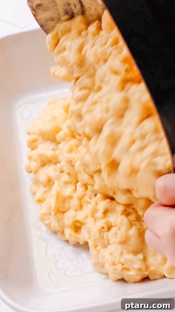 Mac and Cheese Perfection: The Ultimate Golden Sauce 10 Transferring macaroni and cheese to casserole.