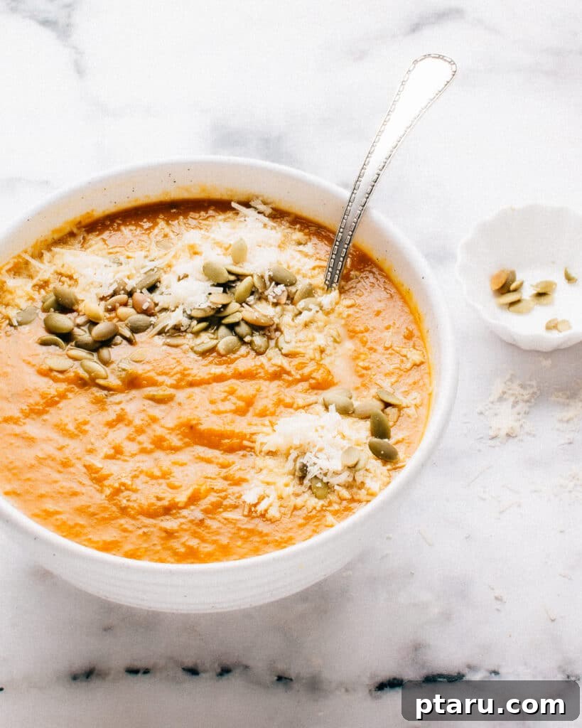 Golden Harvest Squash Puree 2 A steaming bowl of vibrant Autumn Squash Soup, garnished with fresh sage leaves.