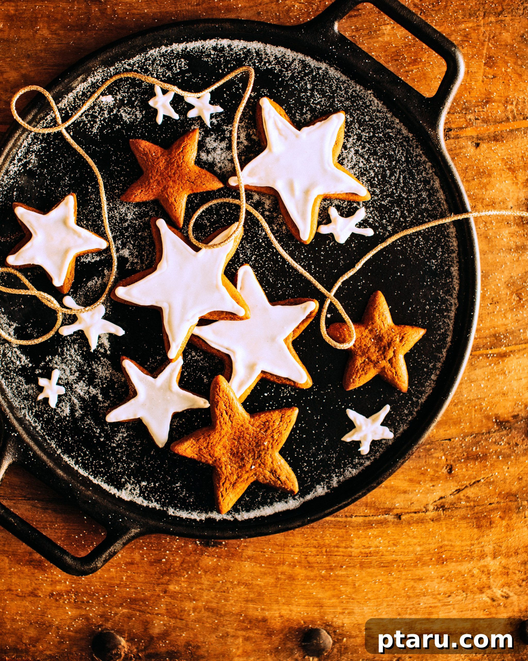 Gingerbread Starlight Cookies 3 A collection of beautifully decorated star-shaped gingerbread cookies arranged on a rustic wooden table, bathed in warm, golden light.