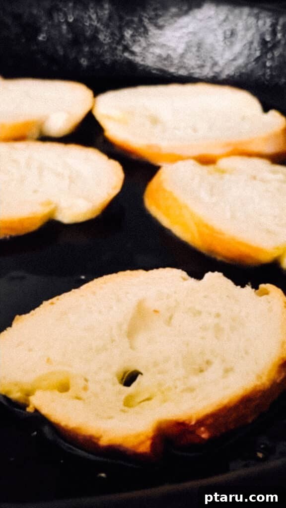 Jeweled Goat Cheese with Pomegranate and Pistachios 6 Toasting crostini in a pan.