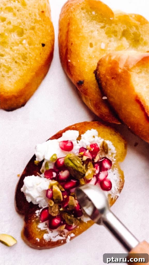 Jeweled Goat Cheese with Pomegranate and Pistachios 8 Adding the toppings to the goat cheese appetizer.