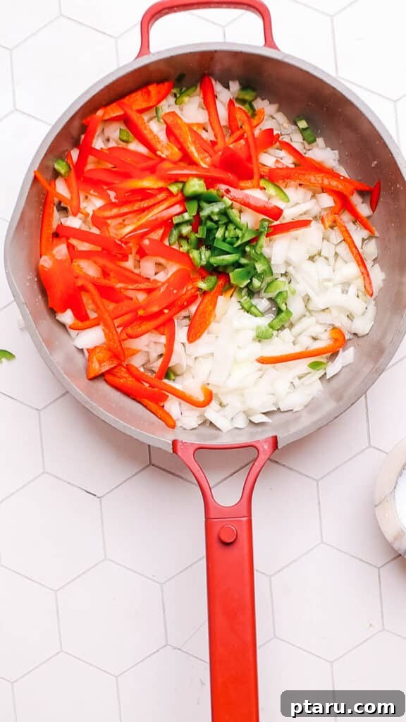 Your New Favorite Quick Coconut Curry Chicken 4 Adding chopped vegetables and onions to a hot pan with oil, beginning the sautéing process for the curry base.