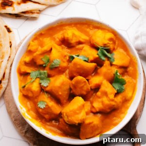 Indian Coconut Curry Chicken in a bowl topped with cilantro.