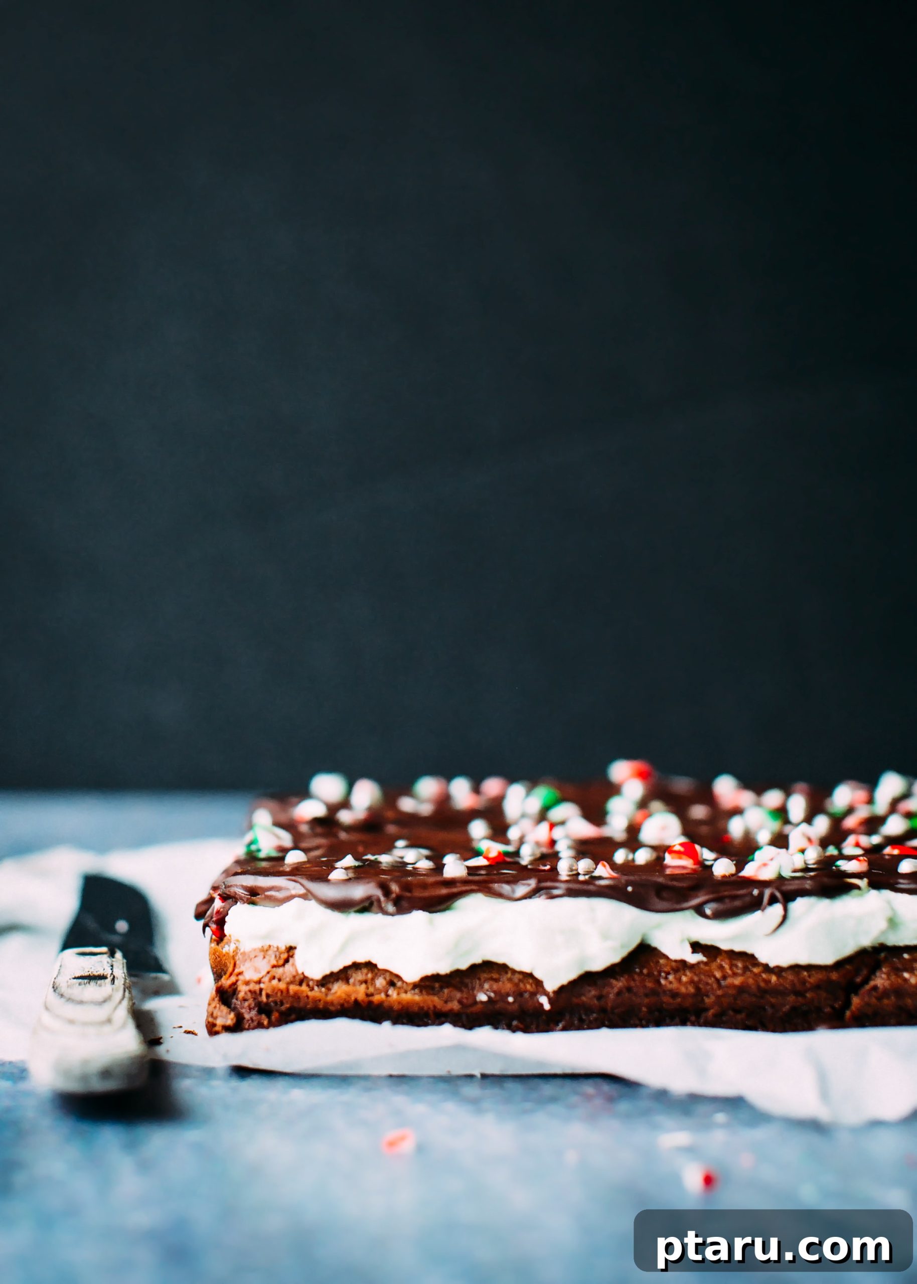 Decadent Peppermint Chocolate Brownies 3 Close-up of a festive chocolate mint Christmas brownie with white icing